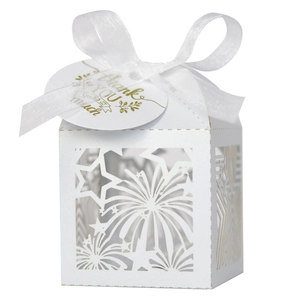 White laser cut gift box with star patterns, white ribbon, and Thank You tag on plain background