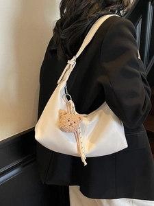 Chic beige half-moon hobo bag for women with cute bear charm and striped ribbon