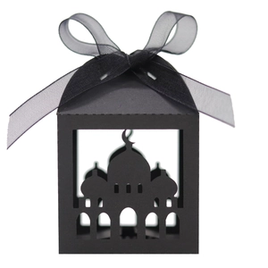 Detail of laser-cut black gift box with mosque motif and black ribbon bow for Ramadan