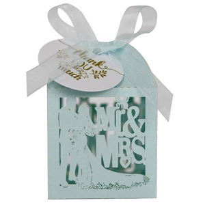 Detail of mint blue laser-cut wedding candy box with Mr & Mrs silhouette and ribbon