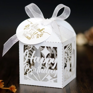 Detailed laser-cut Happy Birthday favor box with white ribbon and gold thank you tag