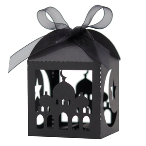 Detail of black laser-cut candy box featuring hollow mosque moon star pattern and silk bow