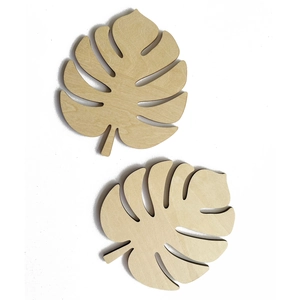 Leaf-shaped wooden coasters made of natural plywood with laser-cut monstera design