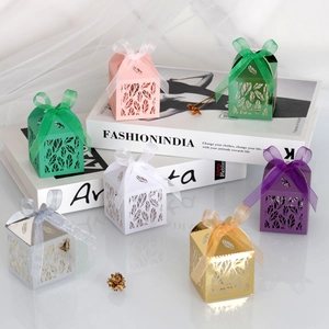 Detail of laser-cut gift boxes in seven colors with elegant leaf patterns and ribbons
