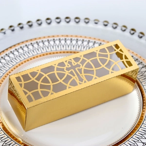 Detailed laser-cut hollow cross design on a shimmering gold wedding favor gift box