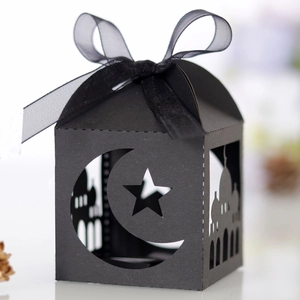 Elegant black laser-cut Ramadan gift box with moon and star patterns and ribbon