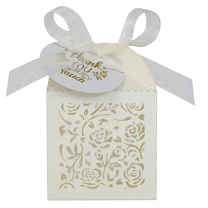 Detail of laser-cut ivory gift box with rose patterns and thank you tag with satin ribbon