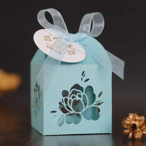 Light blue laser-cut floral wedding favor gift box with ribbon and thank you tag