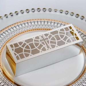 Detailed laser-cut hollow cross pattern on white and gold religious candy gift boxes