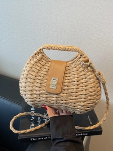 Fashionable woven straw crossbody beach bag with yellow leather flap and metal twist lock