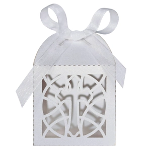 Detail of white laser-cut cross gift box with elegant satin ribbon for wedding baptism