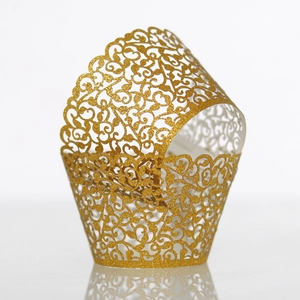 Detail of laser-cut gold glitter vine pattern on luxury paper cupcake wrappers
