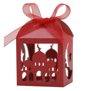 Detail of red laser-cut candy box with mosque silhouette, crescent and ribbon