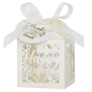 Detail of white laser-cut Happy Birthday favor box with ribbon and thank you tag
