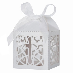 White laser-cut candy gift box with cross pattern and white ribbon for wedding baptism