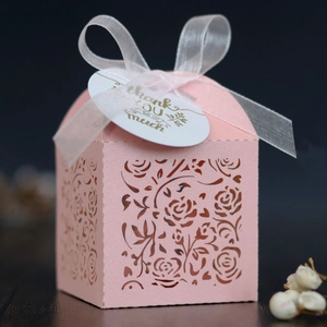 Close-up of pink laser-cut flower gift box with ribbon and Thank You gold foil tag
