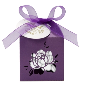 Detail of purple laser-cut flower gift box with silk ribbon and thank you tag