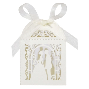 Detailed laser-cut white wedding favor box featuring romantic couple silhouette and bow