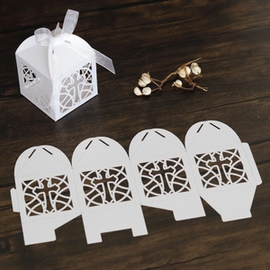 Macro view of white laser-cut cross gift box with ribbon and flat template shown