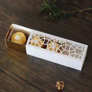 Detailed laser-cut candy box featuring hollow window design with four chocolates inside