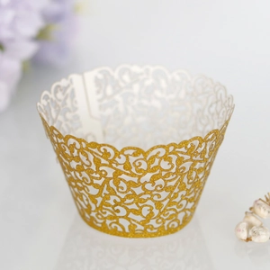 Detail view of laser-cut gold glitter vine pattern cupcake wrapper for party decor
