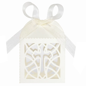 Detail of laser-cut cross pattern and satin ribbon on cream wedding candy gift box