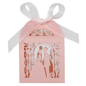Pink laser-cut wedding favor box in house shape with bride and groom silhouette and ribbon
