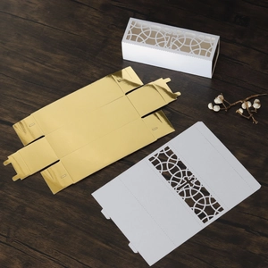 Detail showing the intricate laser-cut cross pattern on the white wedding candy box lid
