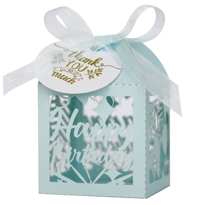 Close-up of light blue laser-cut Happy Birthday candy box with ribbon and thank you tag