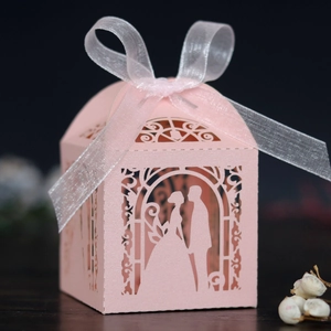 Close-up of pink laser-cut candy box featuring a romantic bride and groom silhouette