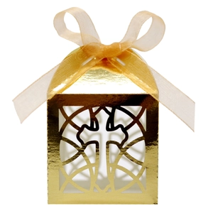 Detail of golden laser-cut favor box with cross design and champagne ribbon bow