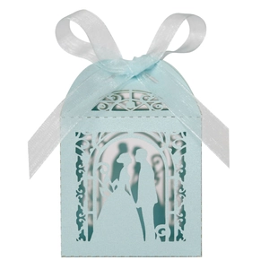 Detail of laser-cut light blue wedding favor box with pearl paper and ribbon bow