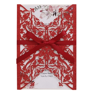 Elegant red laser-cut glitter wedding invitation with a ribbon bow and floral insert card