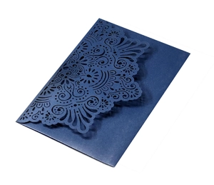 Detailed laser-cut dark blue wedding invitation with intricate lace floral pattern