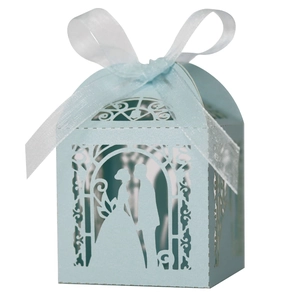 Detailed laser-cut hollow light blue wedding favor box with ribbon bow and silhouettes