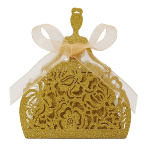 Detail of glitter gold hollow laser-cut candy box with orange ribbon and girl silhouette