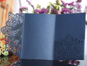 Detail of laser-cut navy blue wedding invitation with pearlescent glitter finish