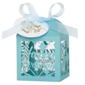 Close-up of light blue laser-cut gift box with Happy Birthday text and silk ribbon