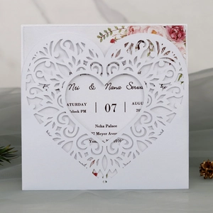 Laser-cut heart wedding invitation card with floral insert on neutral textured fabric