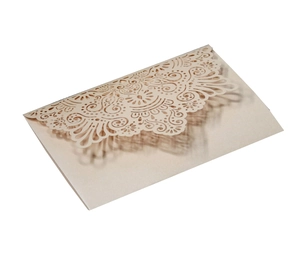 Close-up of laser-cut hollow lace design on elegant champagne pearl paper invitation
