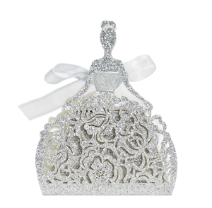 Close-up of glittery princess dress favor box with laser-cut rose patterns and ribbon