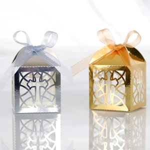 Laser-cut silver and gold cross favor boxes with elegant ribbon bows and mirror finish