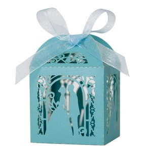 Close-up of laser-cut light blue wedding candy box with intricate floral patterns