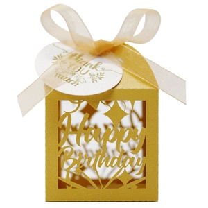 Macro shot of gold laser-cut Happy Birthday candy box with ribbon and gift tag details