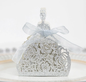 Detail of silver glitter laser-cut princess dress favor box with a blue satin ribbon bow