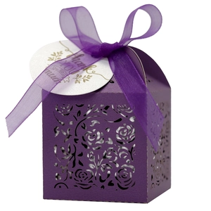 Detail of laser-cut purple gift box with rose pattern, ribbon and thank you tag