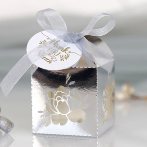 Detail of silver laser-cut floral gift box with mirror finish and Thank You ribbon