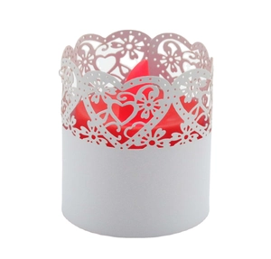 Detailed laser-cut white paper candle wrap with intricate heart and floral patterns