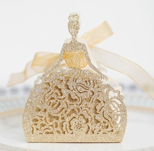 Close-up of glitter hollow rose gold girl candy box with intricate floral patterns