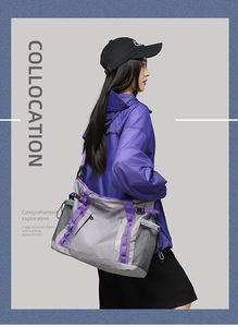 Detail of grey travel bag with purple trim and side mesh pocket worn by a model